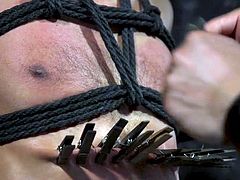 in a leather mask, tied with rope and tortured