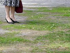Wife walking in black classic high heeled pumps