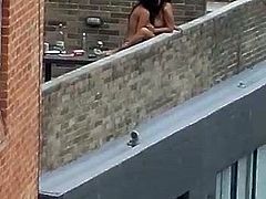 Mistress fucks her whore on rooftop balcony