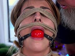 Her hairy pussy gets wetter with every second. Kristen has metal clamps on her nipples, a rope on her eyes and a ball gag in her mouth, in order to drown out groans, as our master constantly affects her cunt with the help of a vibrator. Join and enjoy!