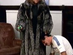 naughty dominating woman in a fur coat and her slave