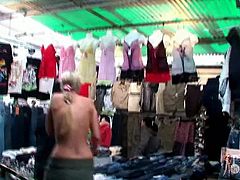 Girl strips naked in an outdoor mall to try on some clothes