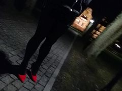 crossdresser walking in public park in heels