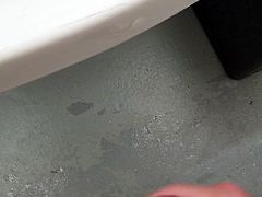 Stroking cock in a public shower room