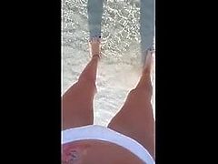 PIssing in a white bikini on the beach