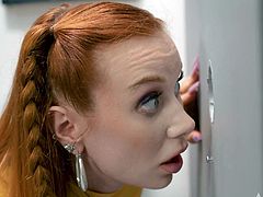 The sexy redhead walks into the bathroom and spots two shemales sticking their cocks through the holes in the wall. She can't resist getting on her knees to suck them off, taking turns deepthroating both of their hard dicks until they cum all over her face. Sign up now to watch!