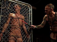 In a dark room, bound to a cage, Christian conjured and tortured his long-lost love, Benvi. He tormented Benvi with a flogger, a paddle, clothespins, and electricity. Then he comes towards his cock and nipples before the tortures get to pleasure himself using his sex slave.